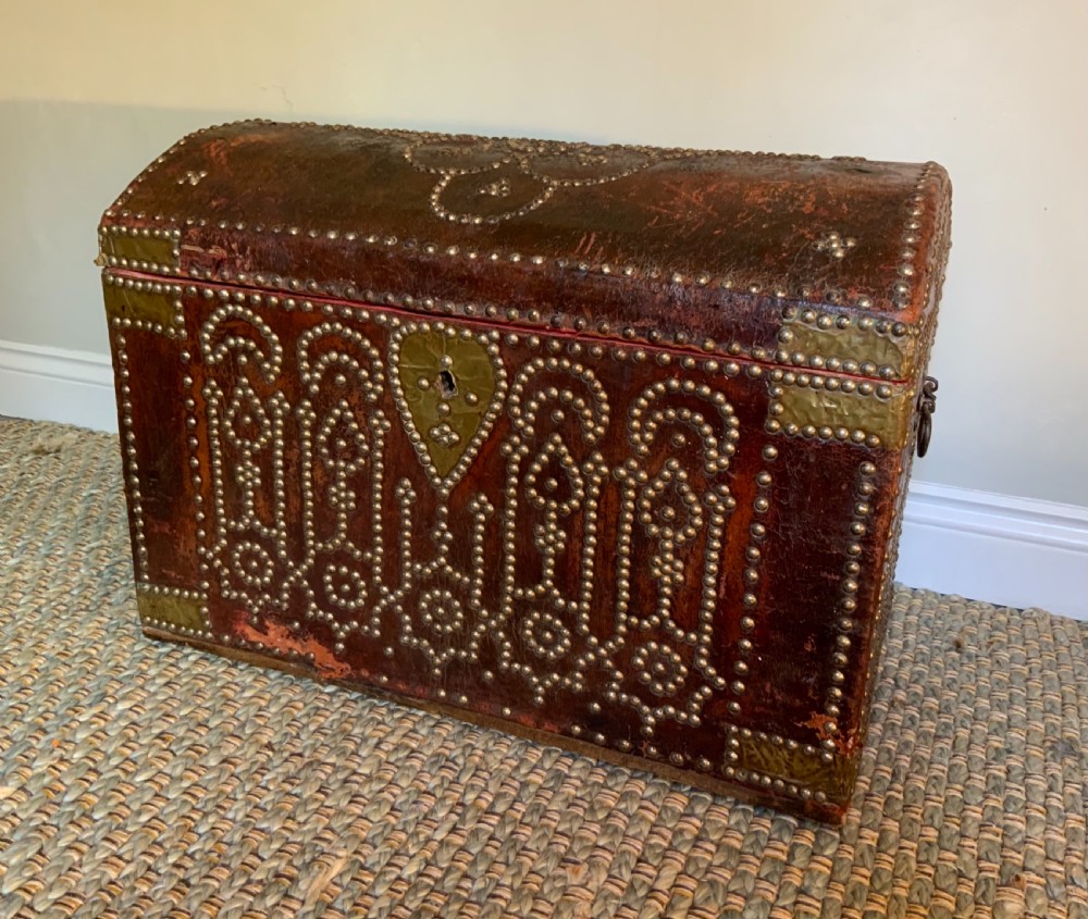 An 18th century red leather travelling trunk