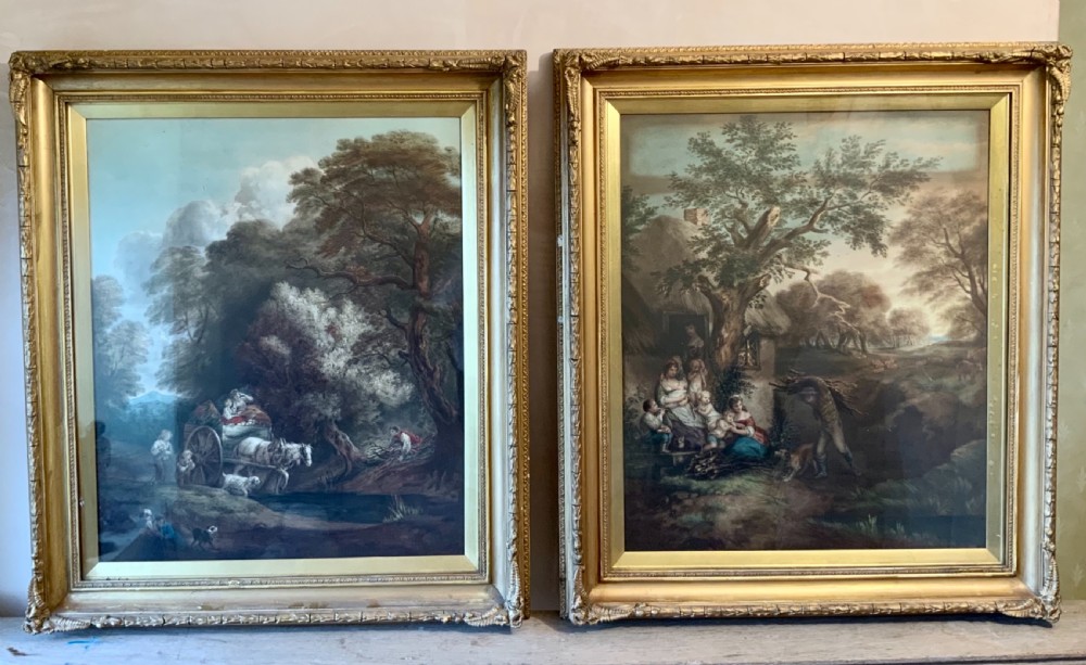 A pair of nineteenth-century mezzotint prints depicting pastoral landscape and cottage scenes, displayed in rectangular giltwood frames with gold slip mounts.