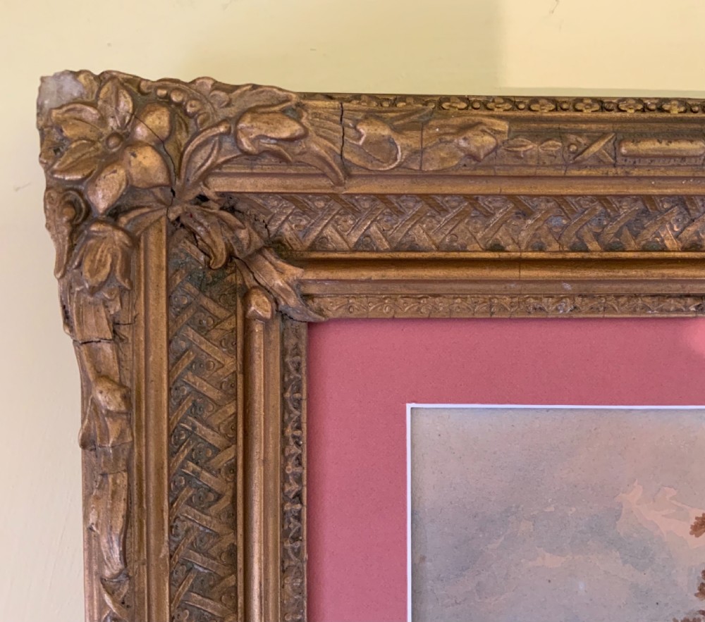 An antique 19th-century watercolour landscape by William Crouch depicting classical ruins, a bridge, and mountains, housed within a pink mount and an ornate gilt frame. View VI