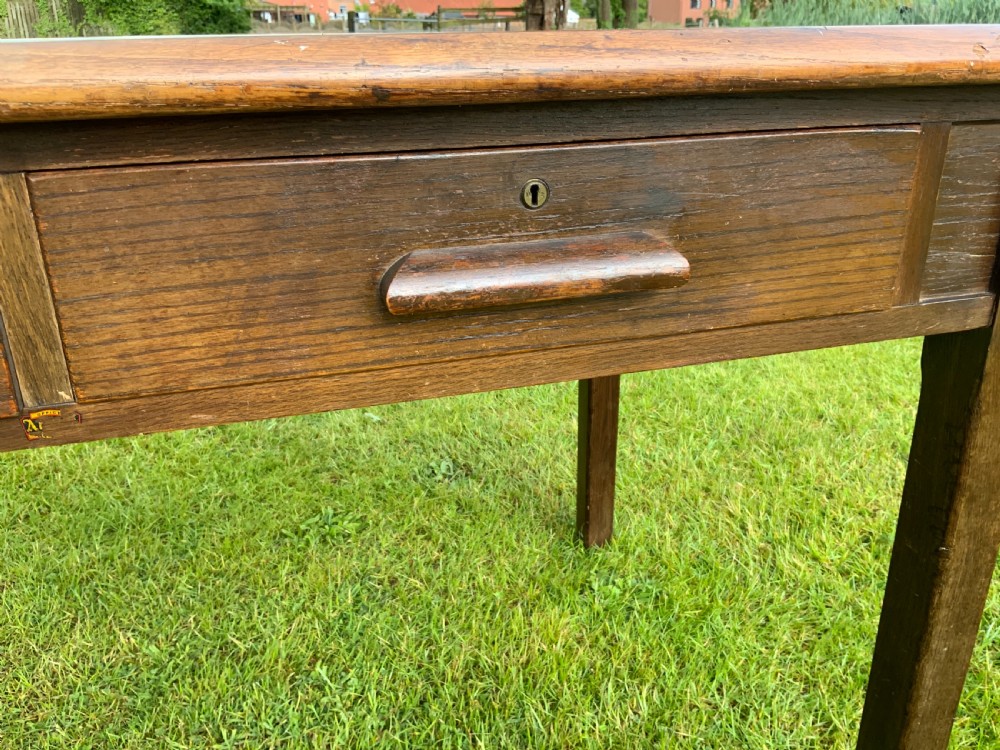 An oak two drawer writing table View II