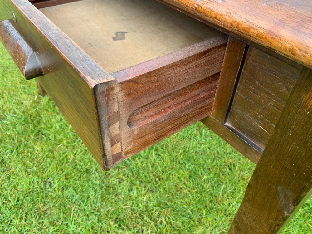 An oak two drawer writing table View V