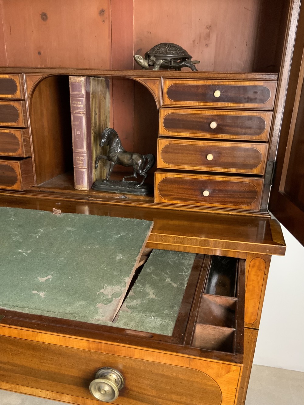 Georgian mahogany writing desk featuring a upper cabinet with oval inlaid panels above a single drawer and tapered square legs. View IV