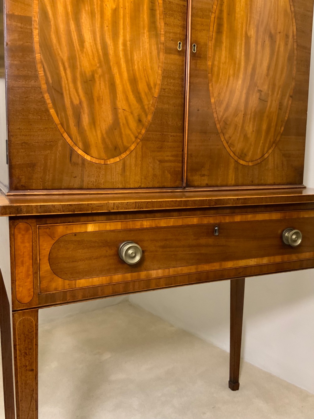 Georgian mahogany writing desk featuring a upper cabinet with oval inlaid panels above a single drawer and tapered square legs. View VII
