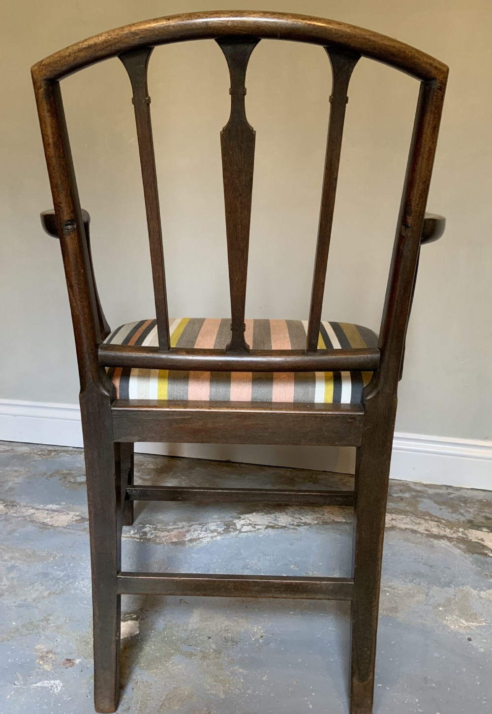 A dark mahogany Georgian open armchair with slender vertical back splats, sweeping armrests, and a multi-coloured striped upholstered seat. View IV