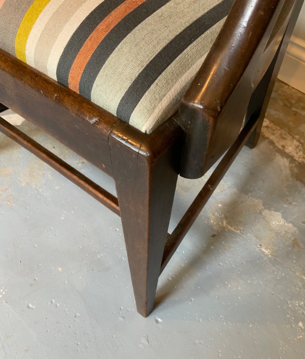 A dark mahogany Georgian open armchair with slender vertical back splats, sweeping armrests, and a multi-coloured striped upholstered seat. View V