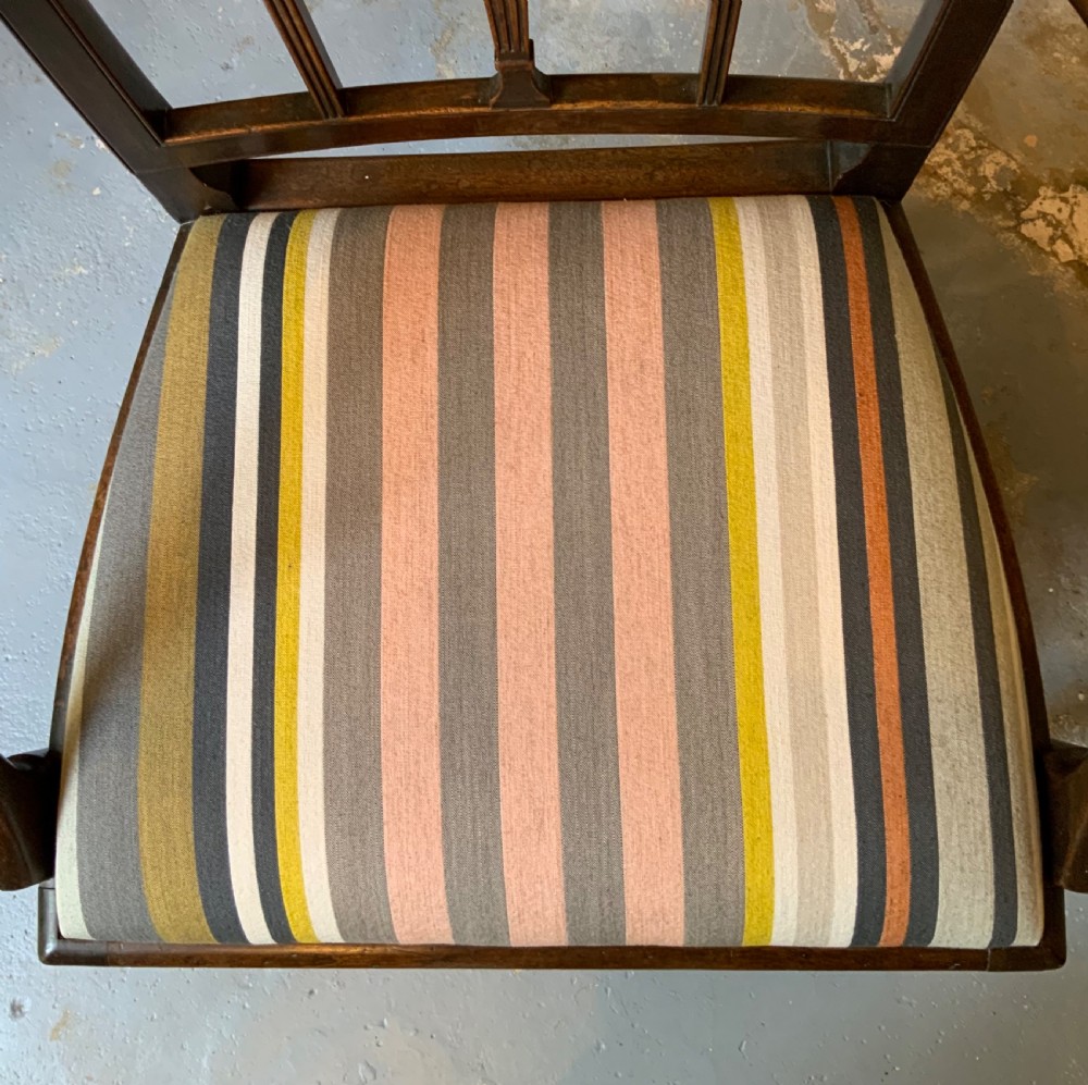 A dark mahogany Georgian open armchair with slender vertical back splats, sweeping armrests, and a multi-coloured striped upholstered seat. View VII