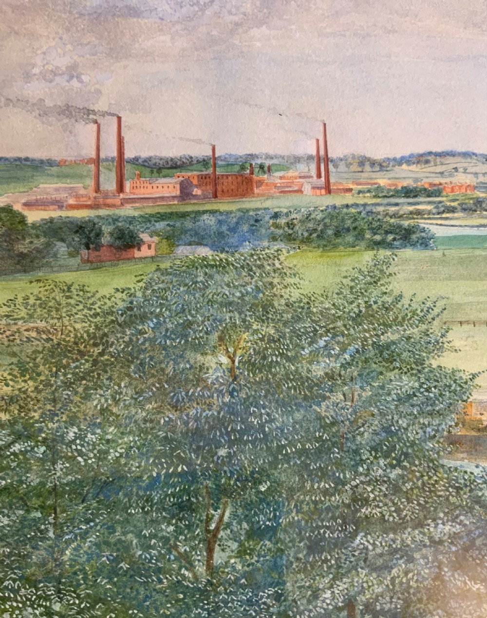 A panoramic watercolour painting depicting a river and manicured gardens in the foreground, expanding to fields and distant factory chimneys under a cloudy sky. View II