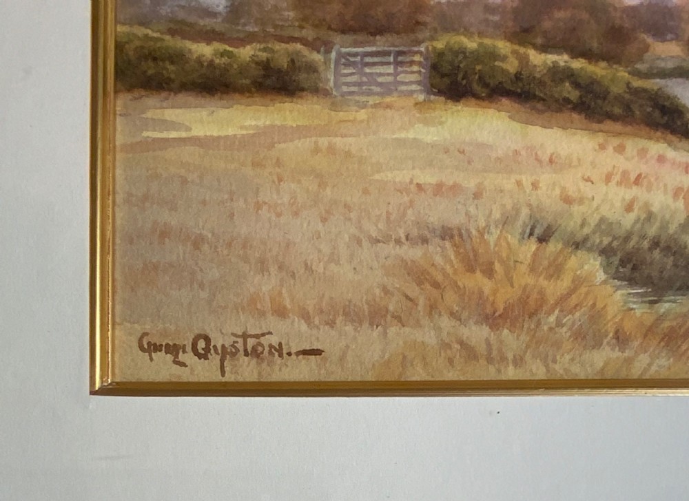 A pair of framed watercolour paintings depicting peaceful rural landscapes with rivers and trees, housed in gold-toned wooden frames. View III