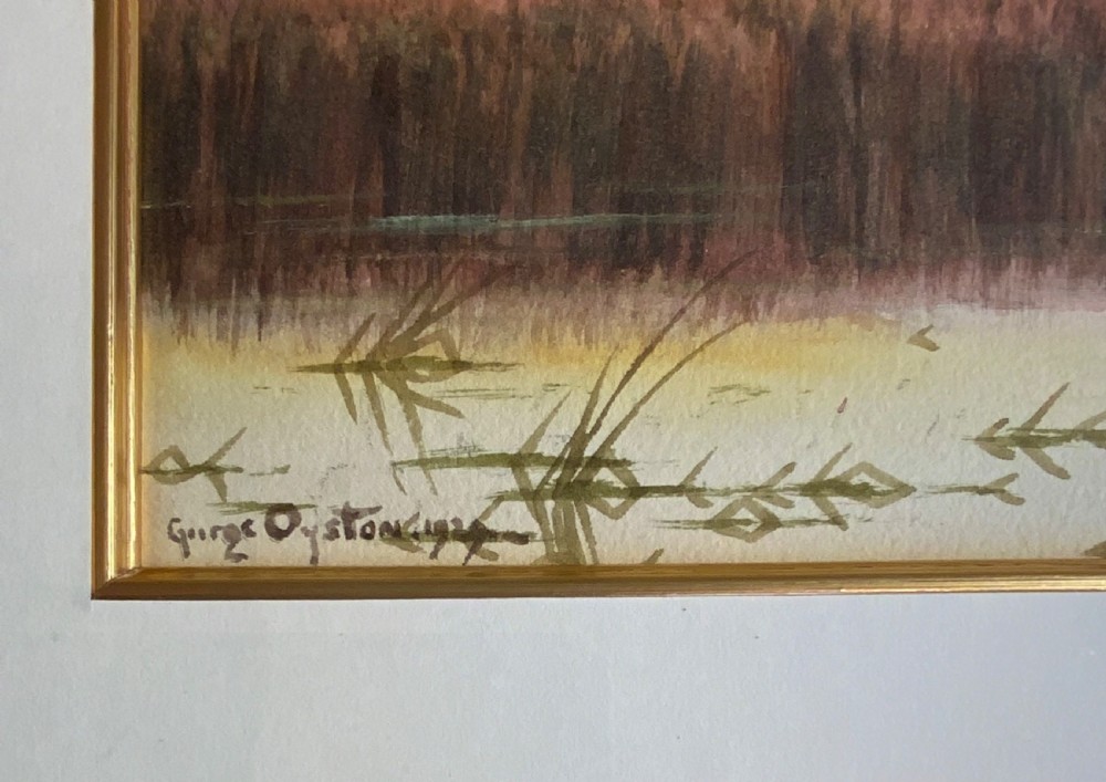 A pair of framed watercolour paintings depicting peaceful rural landscapes with rivers and trees, housed in gold-toned wooden frames. View IV