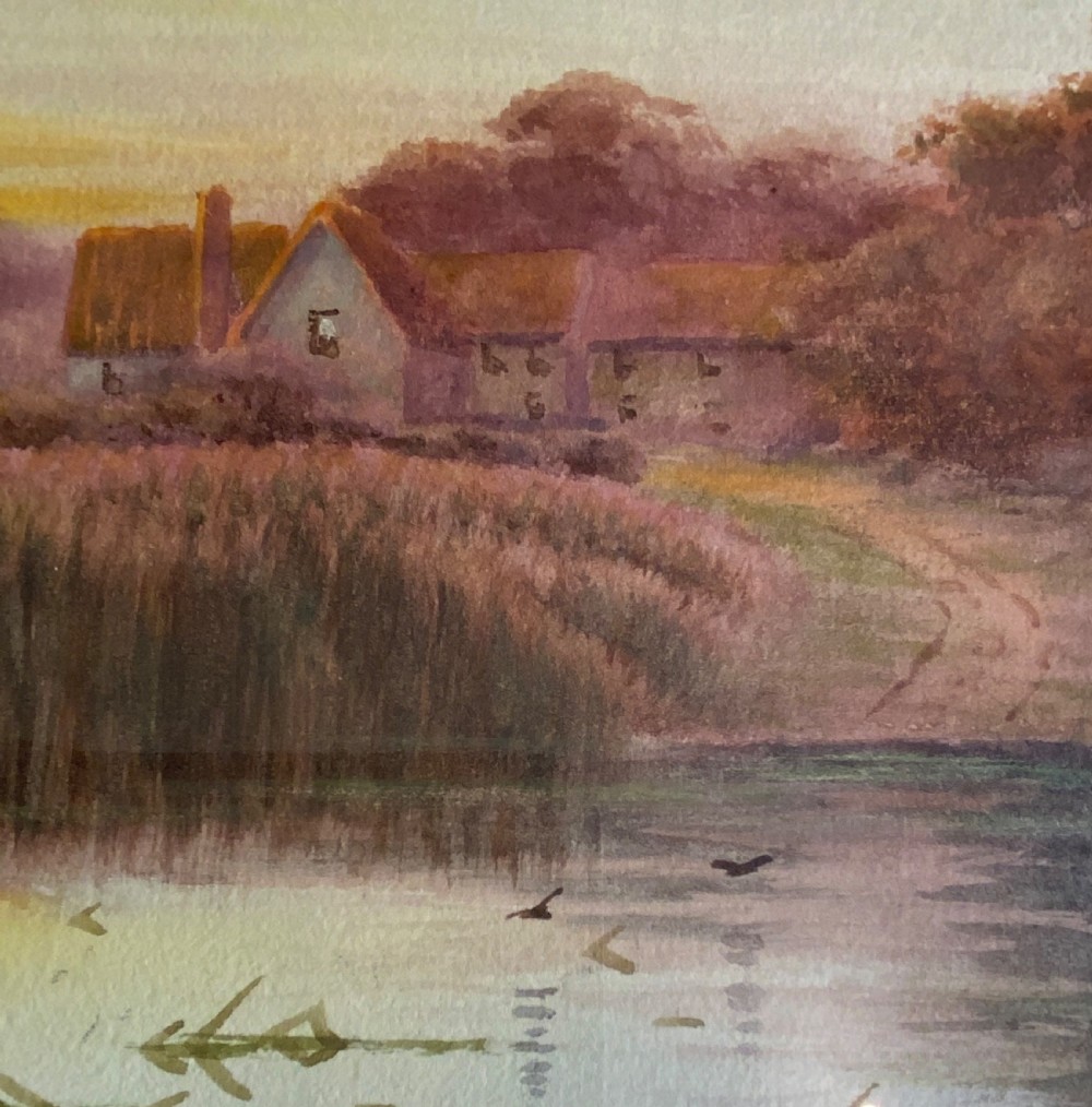 A pair of framed watercolour paintings depicting peaceful rural landscapes with rivers and trees, housed in gold-toned wooden frames. View V