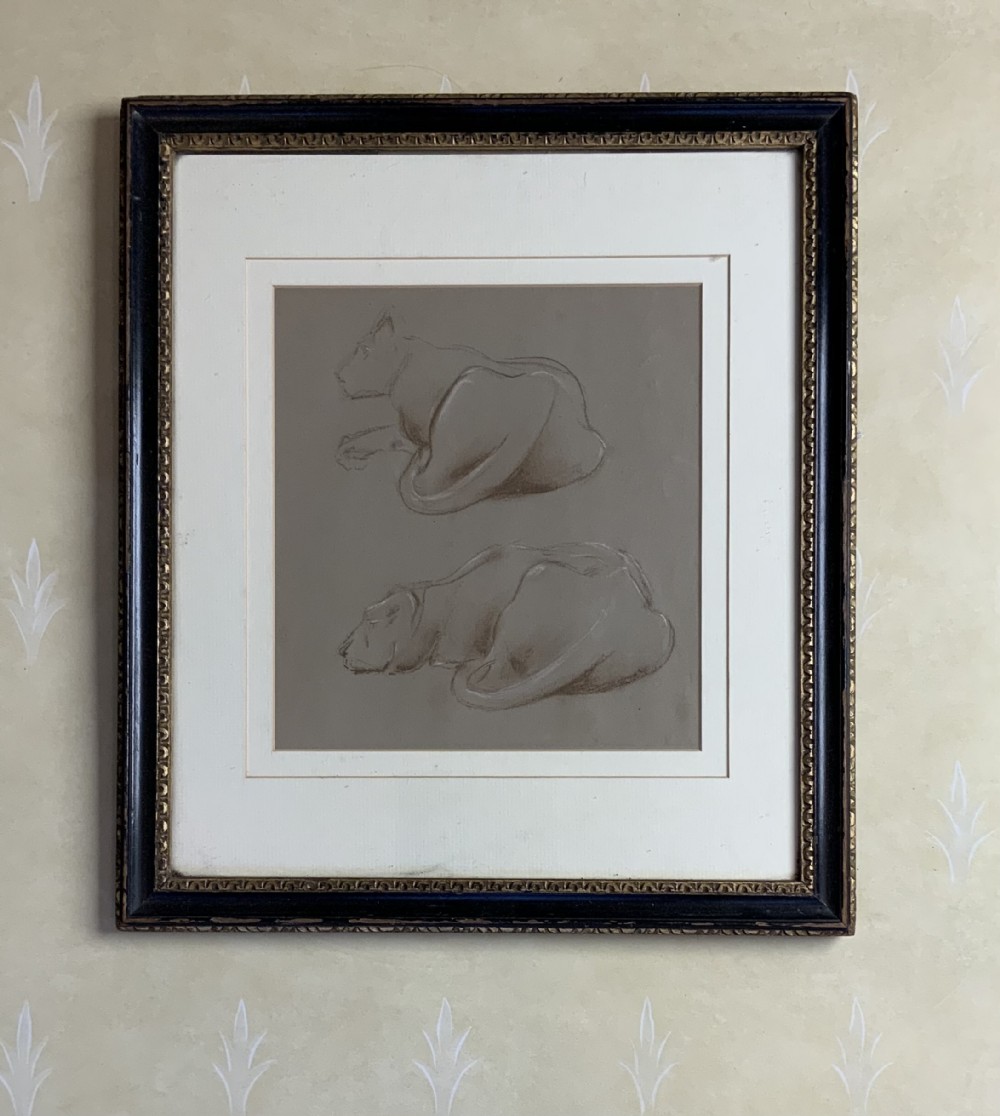 A framed study on grey paper featuring two charcoal and chalk drawings of resting big cats within a black and gold moulded frame.