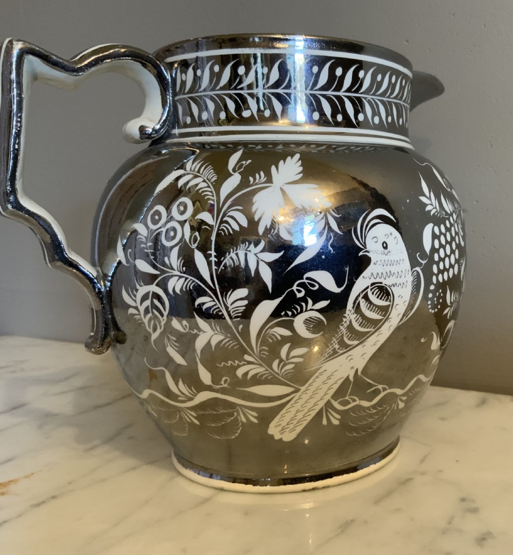 An early 19th century silver resist pottery jug View III