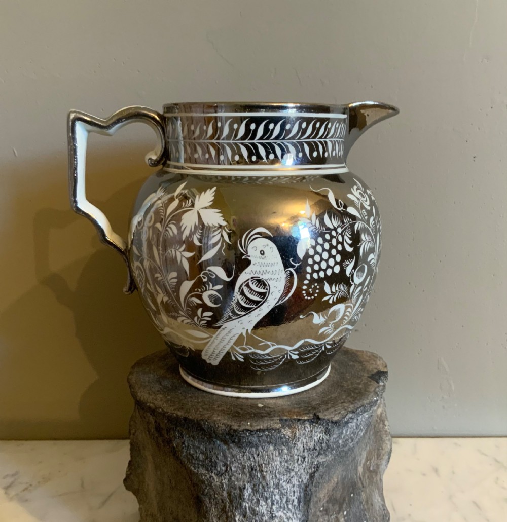 An early 19th century silver resist pottery jug