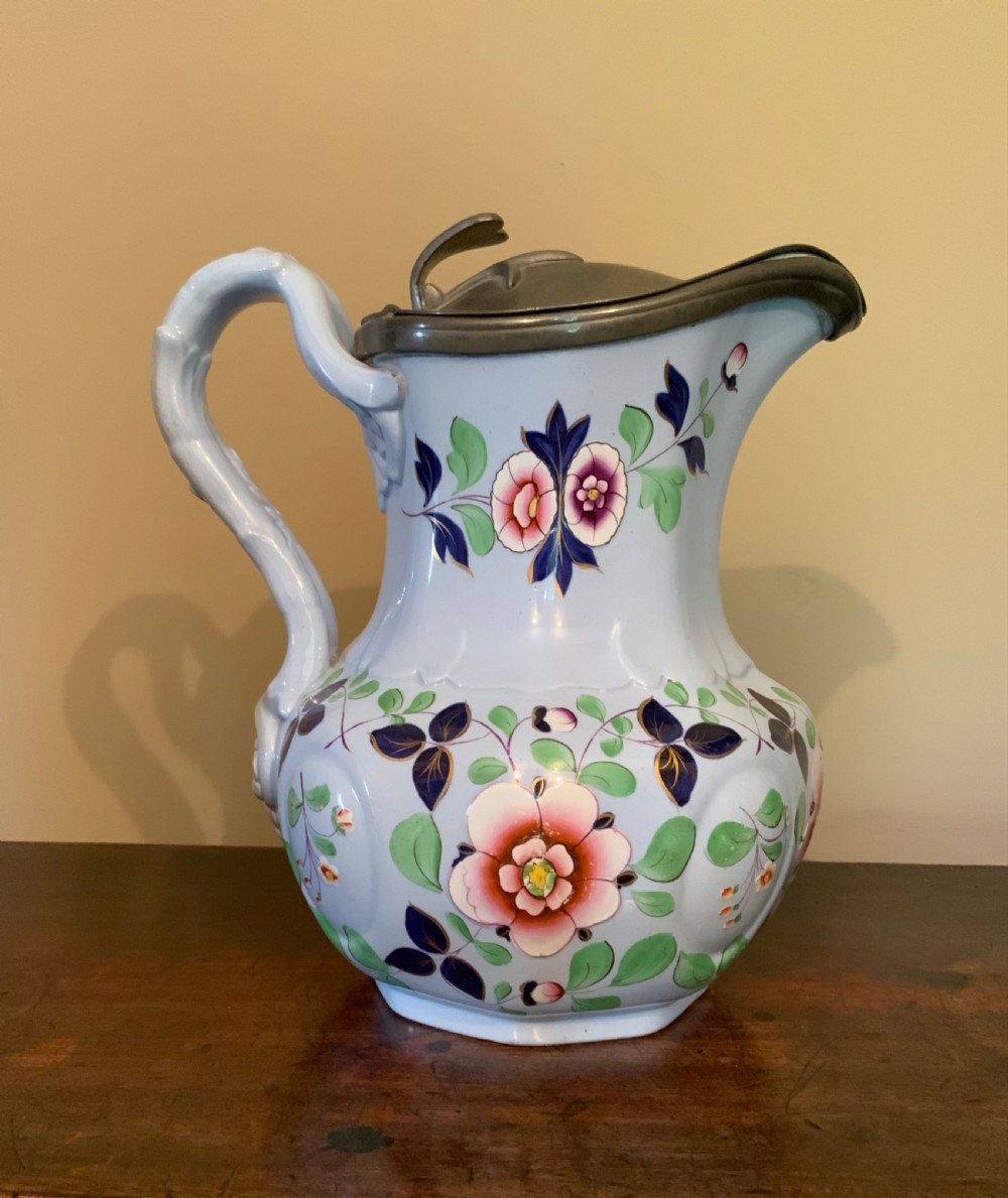 A trio of Pompeii design pottery jugs View X