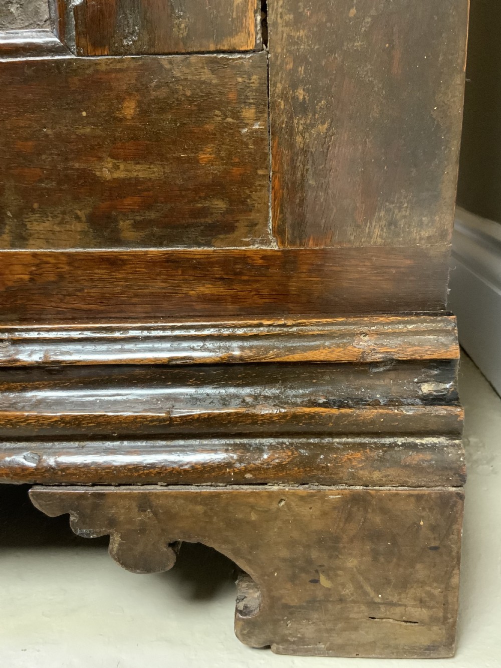 An Italian walnut Baroque cabinet featuring a single door decorated with relief carvings of an urn and floral garlands on a moulded plinth base. View III