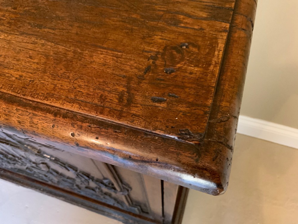 An Italian walnut Baroque cabinet featuring a single door decorated with relief carvings of an urn and floral garlands on a moulded plinth base. View VIII