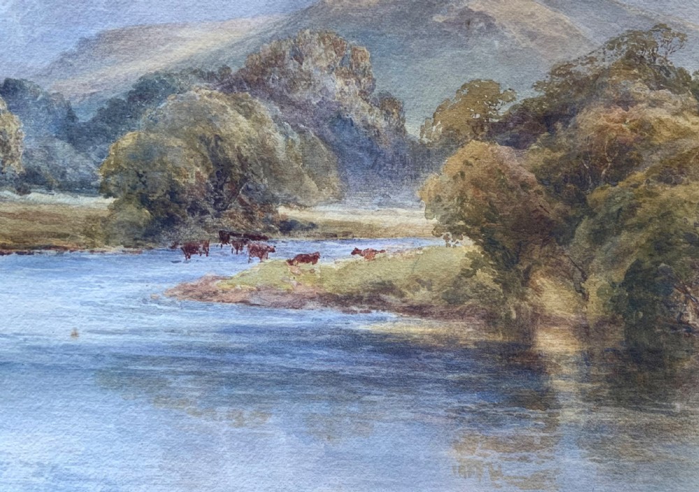 A framed 19th-century watercolour painting depicting a river running through a green landscape with trees and distant hills, set within an ornate gold gilt frame. View VII