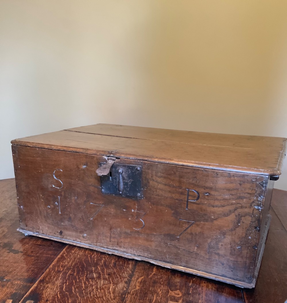 A rectangular warm brown elm bible box with carved initials S and P, dated 1737, featuring a central iron lock plate. View II