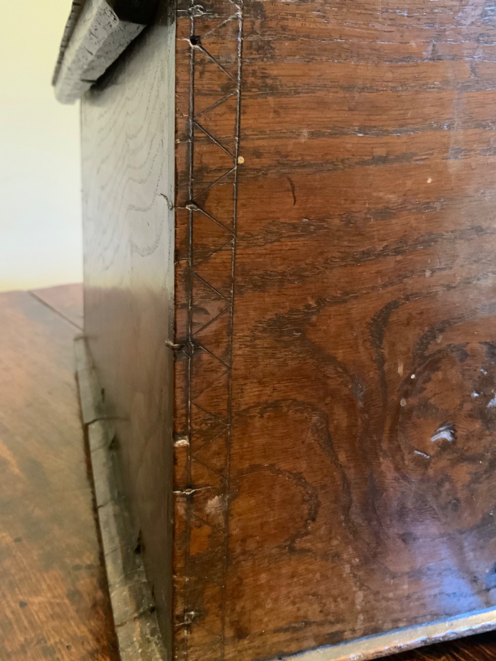 A rectangular warm brown elm bible box with carved initials S and P, dated 1737, featuring a central iron lock plate. View III