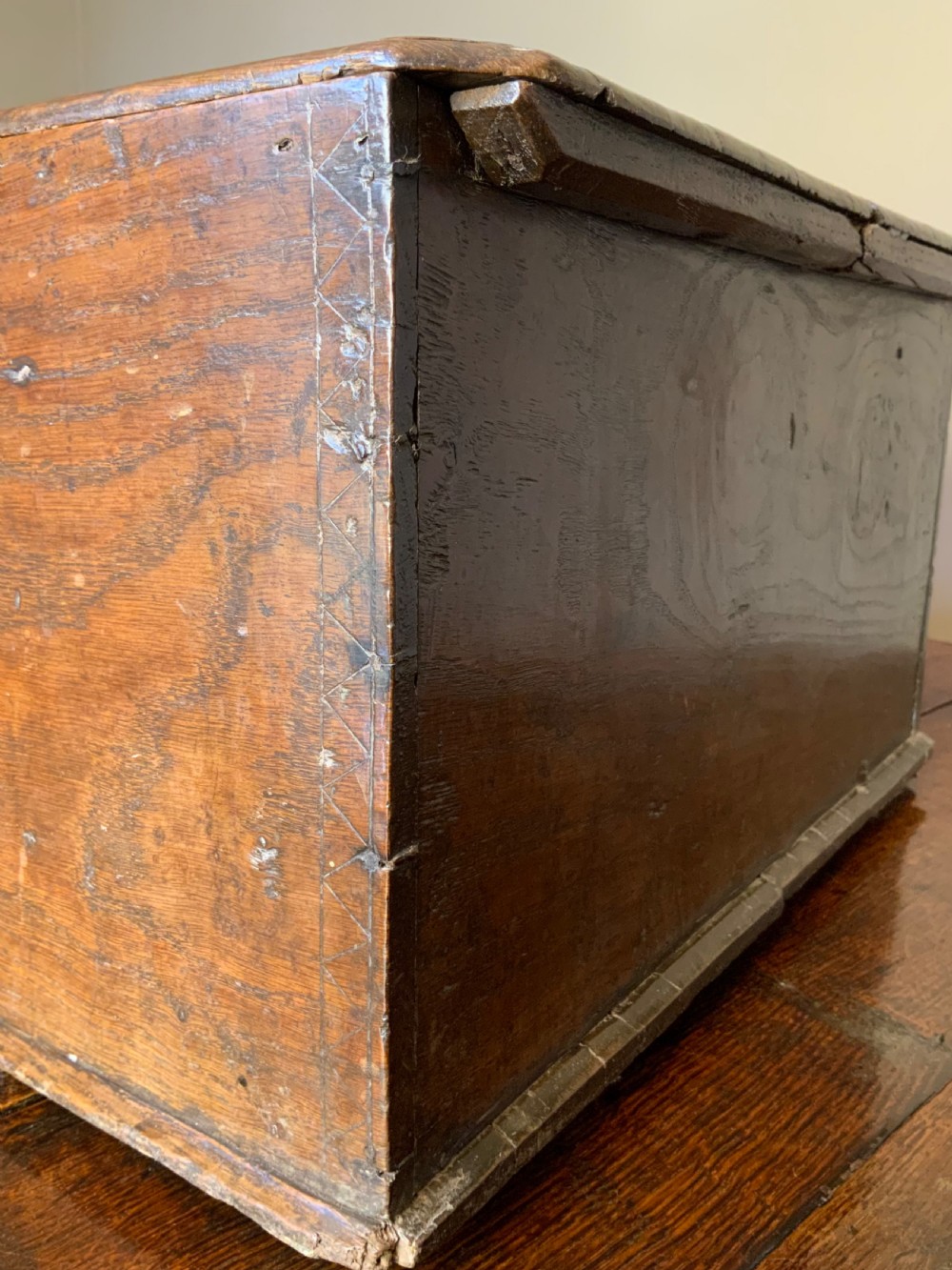 A rectangular warm brown elm bible box with carved initials S and P, dated 1737, featuring a central iron lock plate. View VI