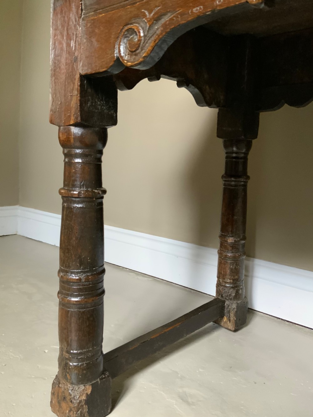 A 17th-century dark oak side table featuring turned legs, carved scroll spandrels, and lower stretcher rails. View III