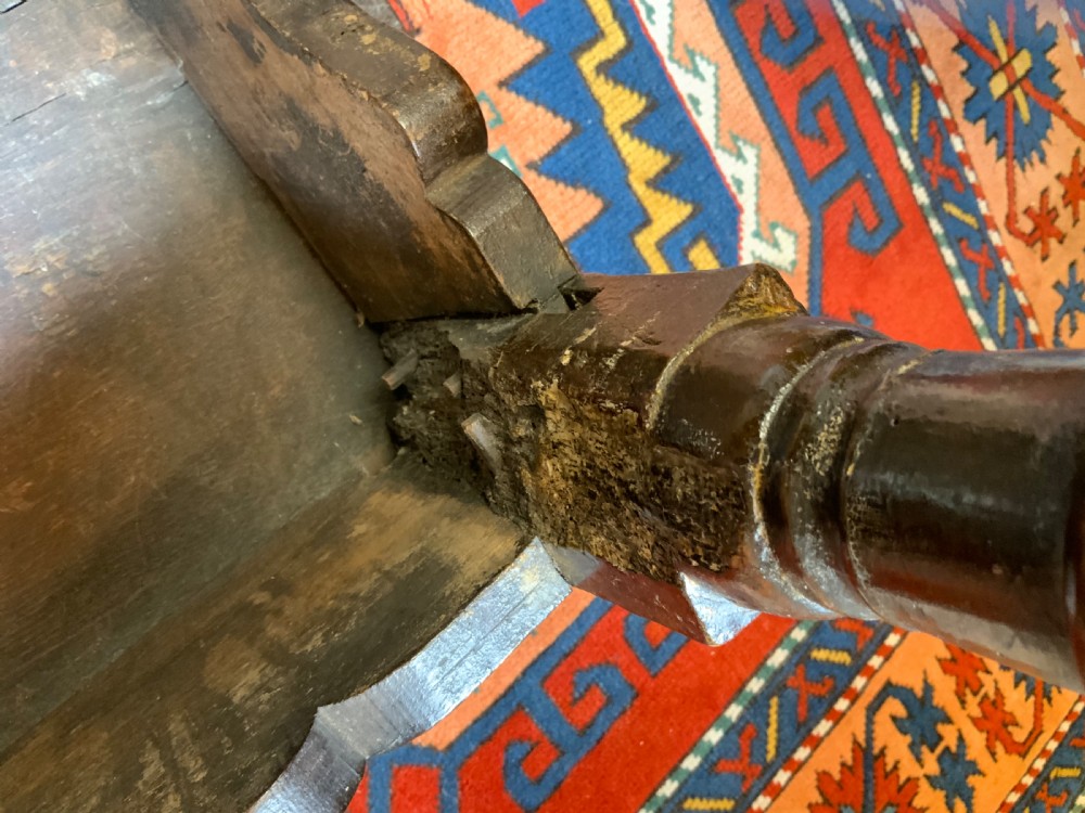 A 17th-century dark oak side table featuring turned legs, carved scroll spandrels, and lower stretcher rails. View VII