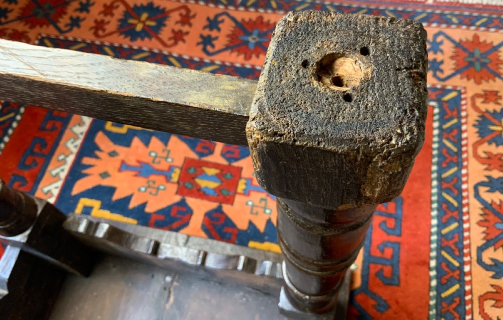 A 17th-century dark oak side table featuring turned legs, carved scroll spandrels, and lower stretcher rails. View IX