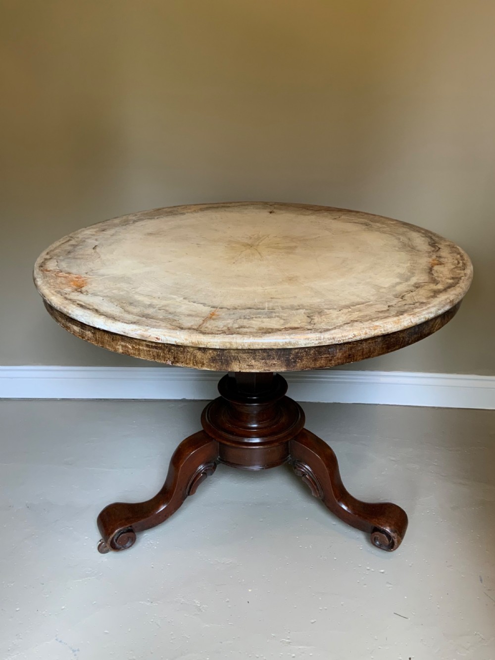 A mahogany based centre table with paint effect top