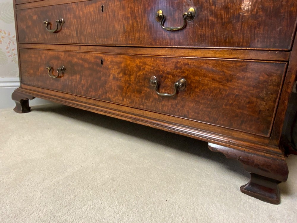 A George III mahogany bureau featuring a sloping front flap over four graduated drawers with brass swan-neck handles and bracket feet. View VI