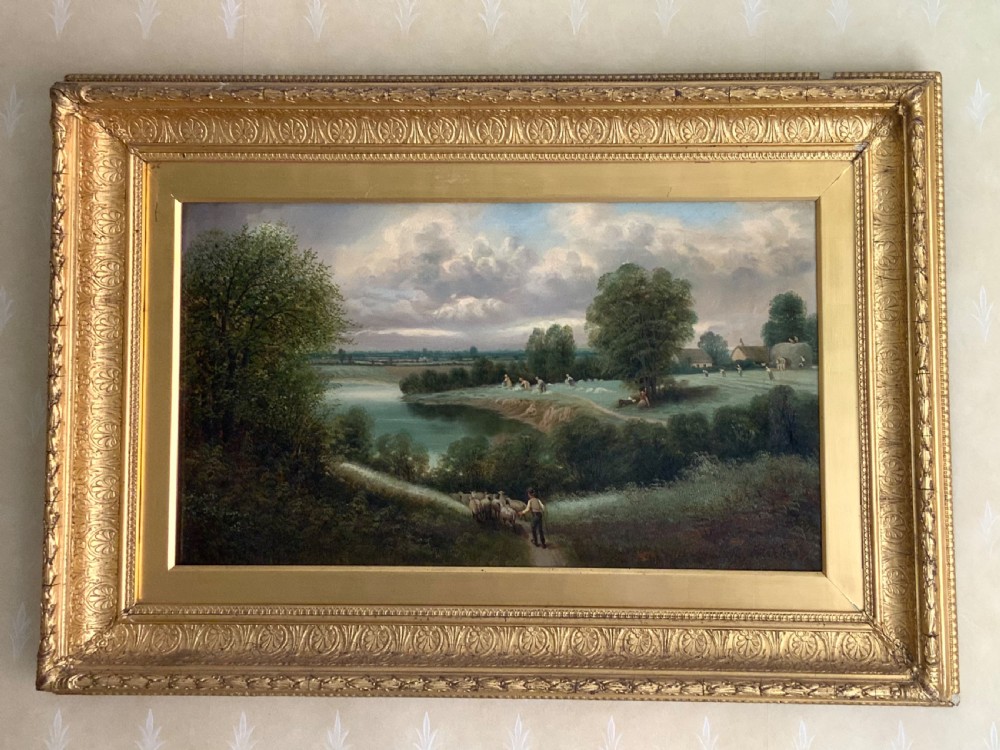 An antique 19th-century pastoral oil painting on canvas showing a shepherd driving sheep along a riverbank, set within an ornate gilded frame.
