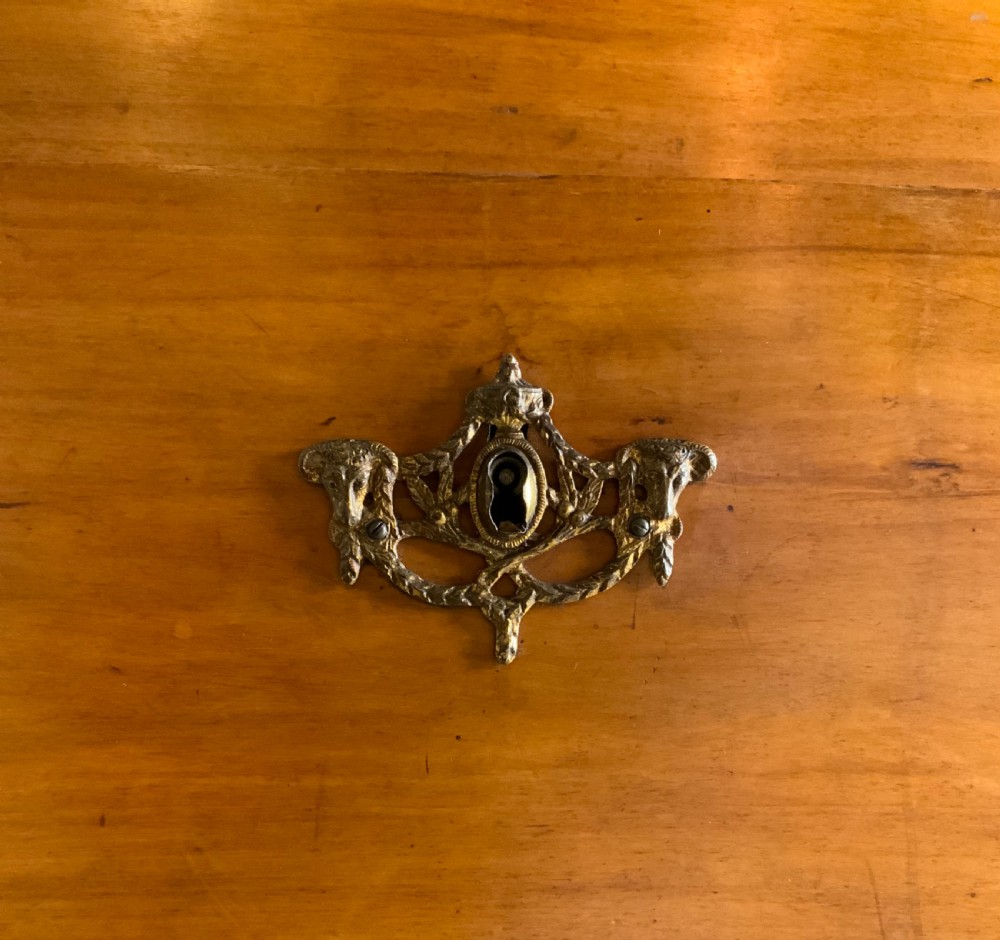 A late 18th-century French Louis XVI style walnut commode featuring three drawers, geometric ebonised inlay, brass hardware, and a dark grey marble top. View VII
