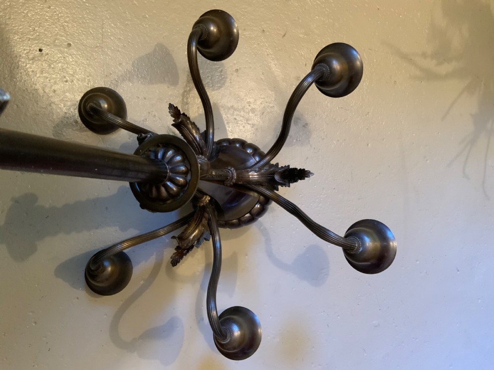 A dark patinated bronze five-arm chandelier featuring downward-facing bell shades, reeded scroll arms, and an ornate central stem. View VI