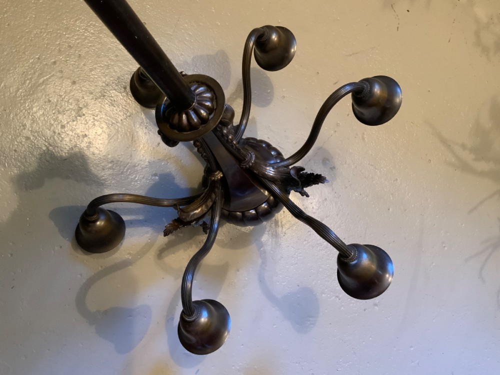 A dark patinated bronze five-arm chandelier featuring downward-facing bell shades, reeded scroll arms, and an ornate central stem. View VII