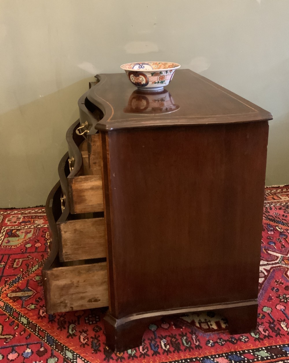 A George III serpentine chest of drawers View II