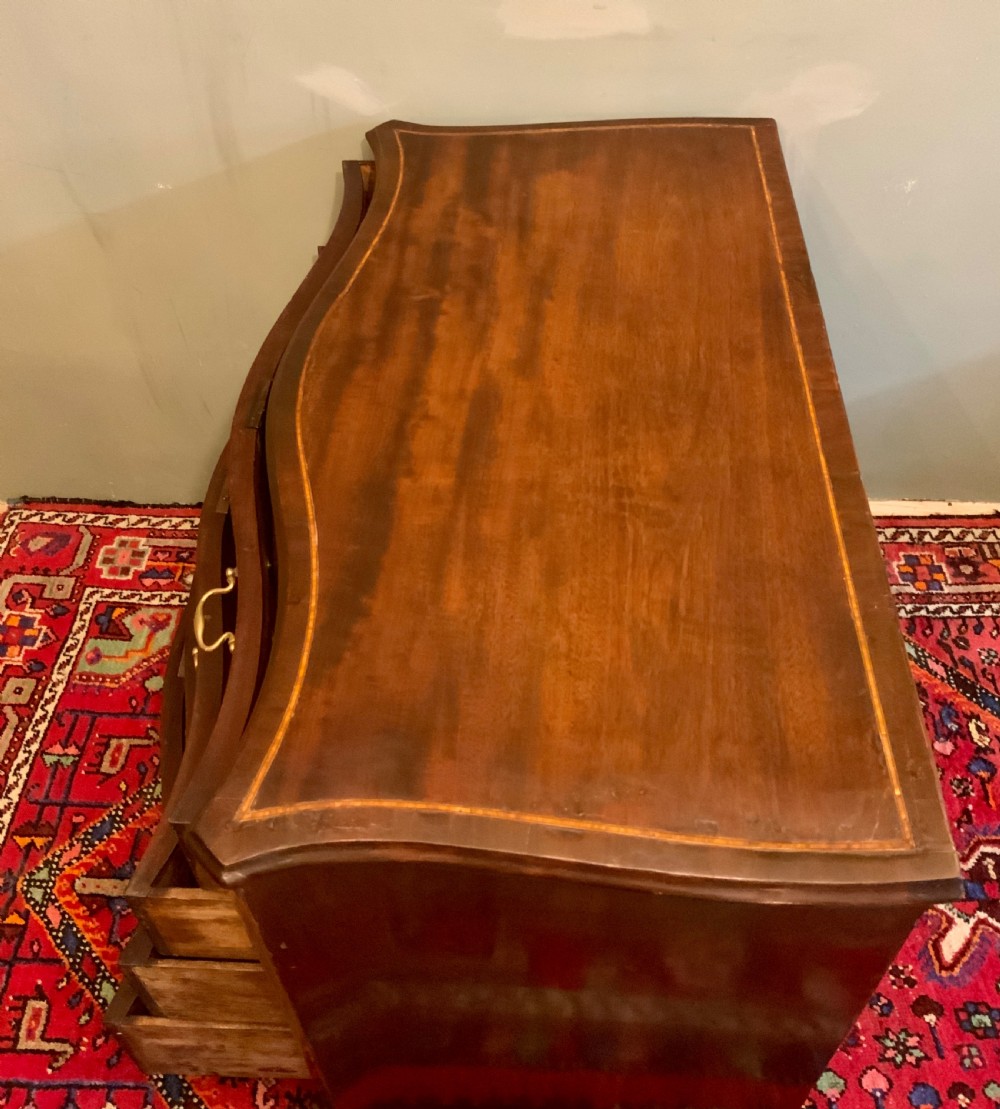 A George III serpentine chest of drawers View V