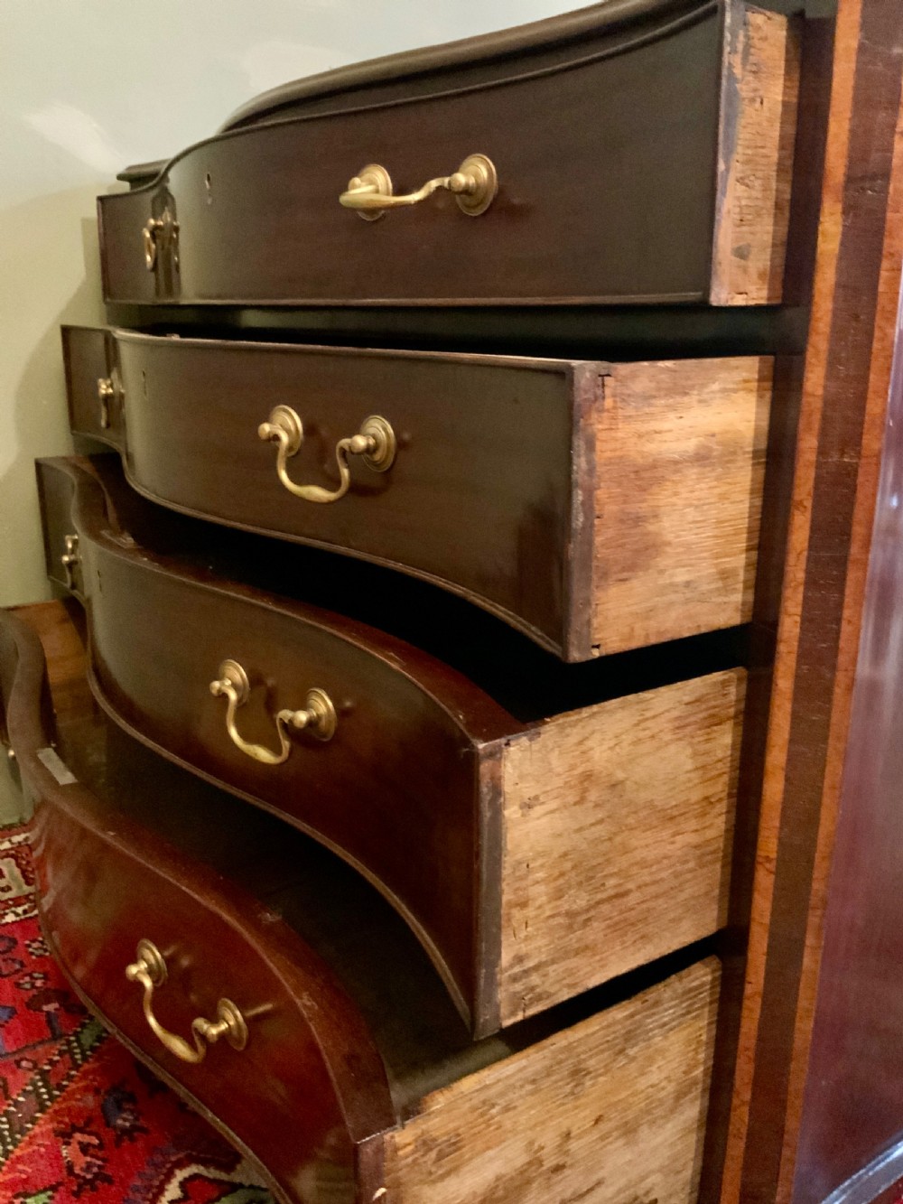 A George III serpentine chest of drawers View VI