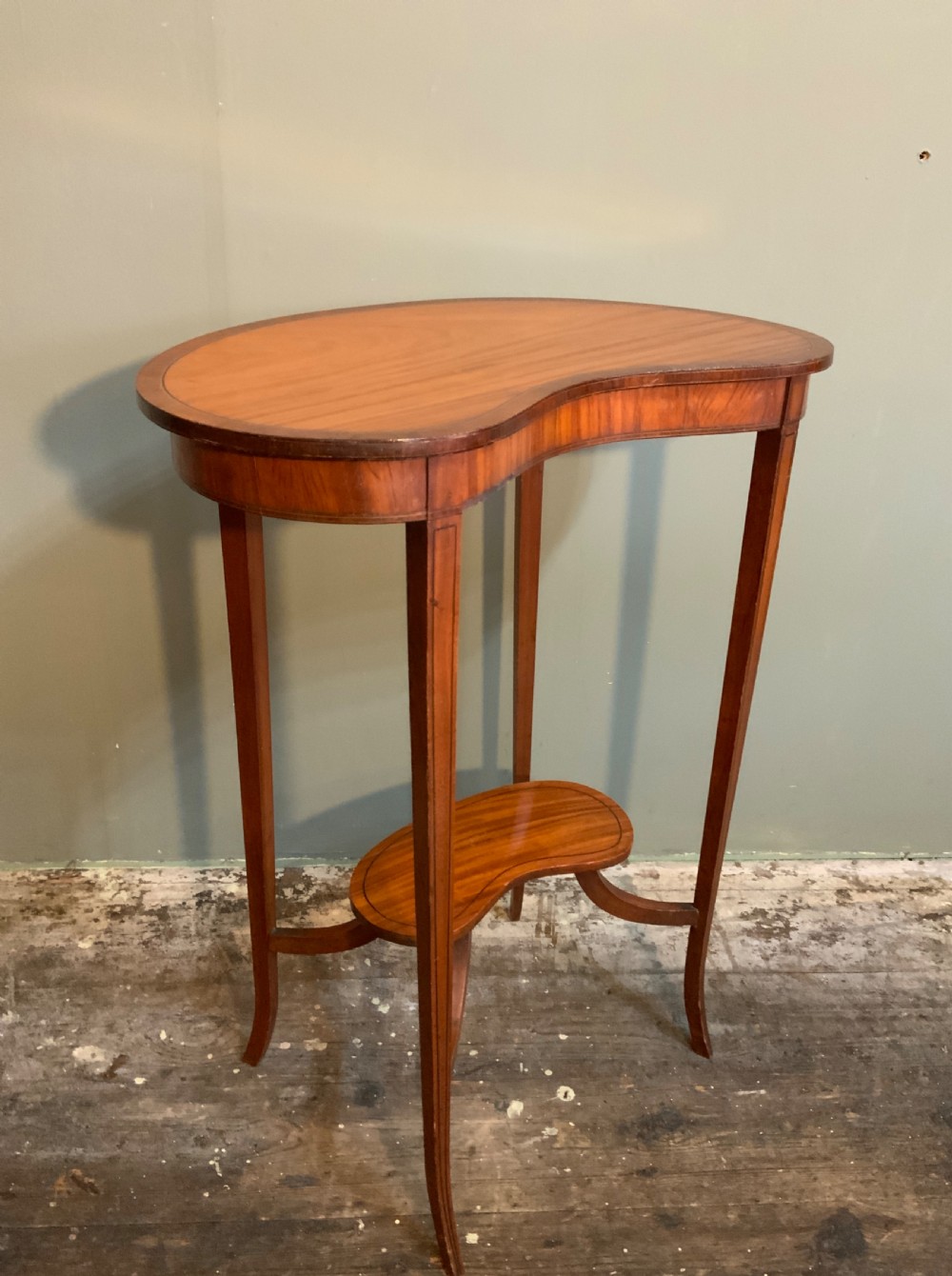 A Satinwood and tulipwood lamp table.