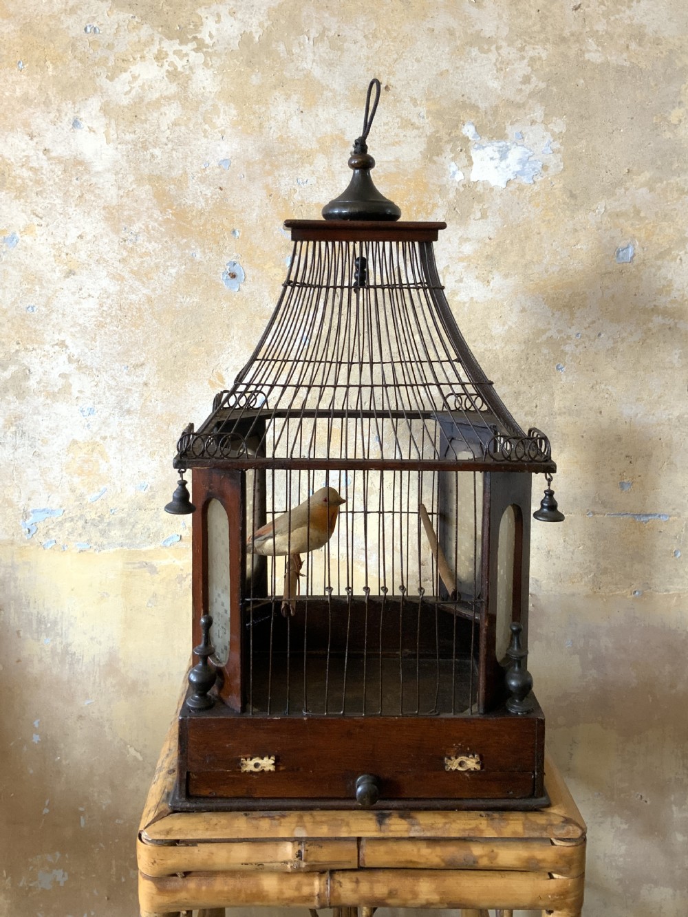 A Victorian pine and wirework birdcage