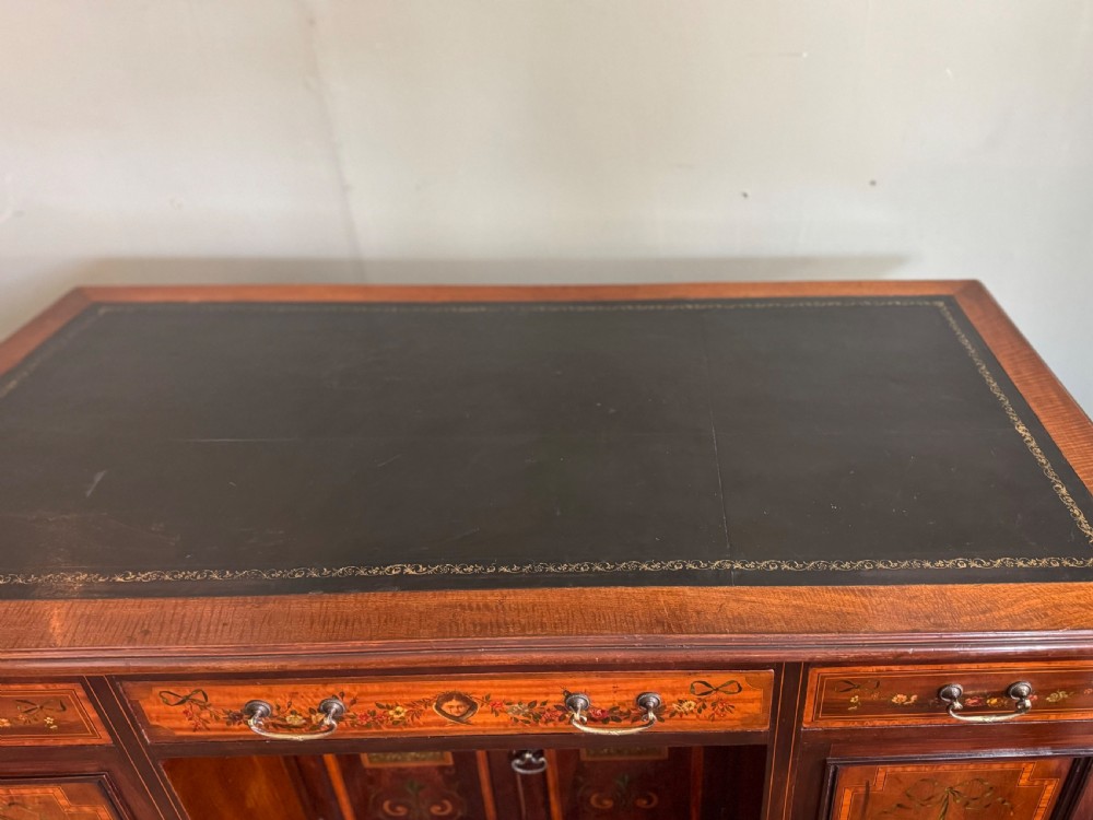 An Edwardian mahogany desk with painted swags and musical trophies View IX