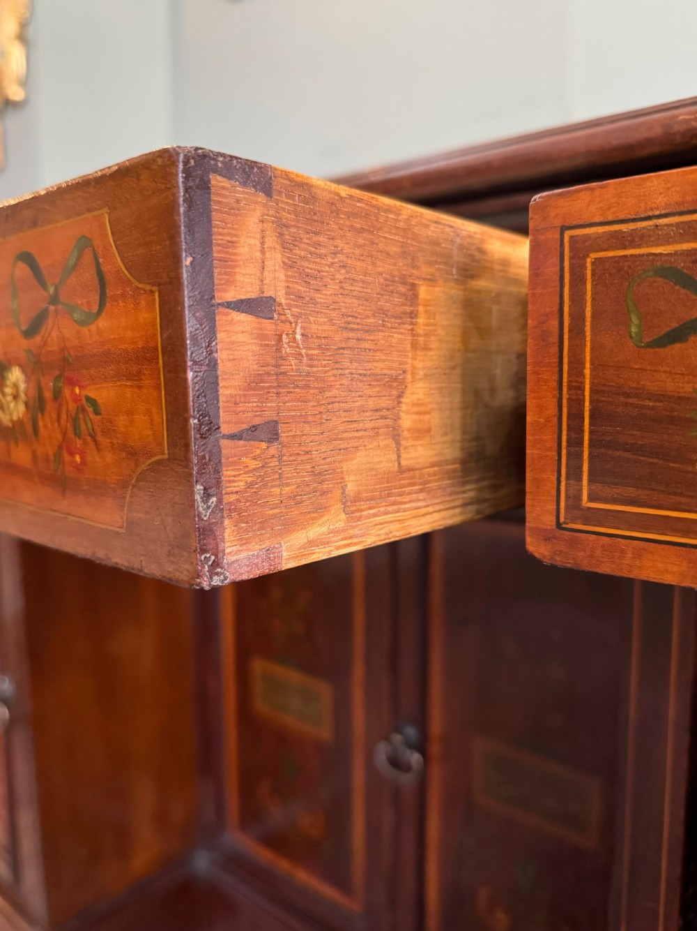 An Edwardian mahogany desk with painted swags and musical trophies View II