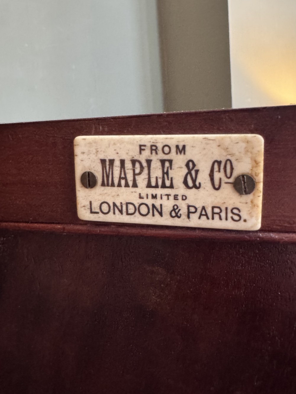An Edwardian mahogany desk with painted swags and musical trophies View V