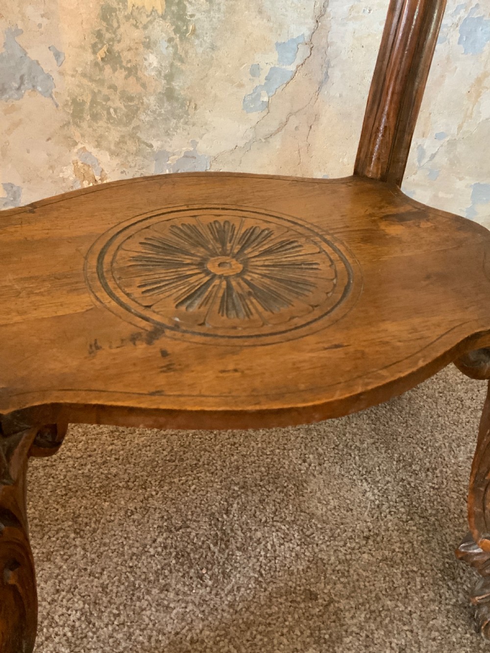 A carved Italian walnut three-legged occasional table featuring sculptural legs shaped like mythical figures terminating in claw feet with a lower undertier shelf. View IV