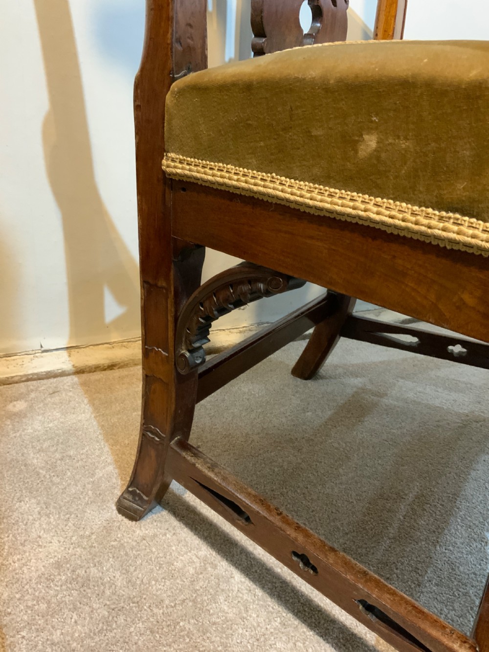 A Georgian dark mahogany armchair featuring an intricately carved pierced back splat, open curved arms, and a green velvet seat with an embroidered tapestry panel. View II