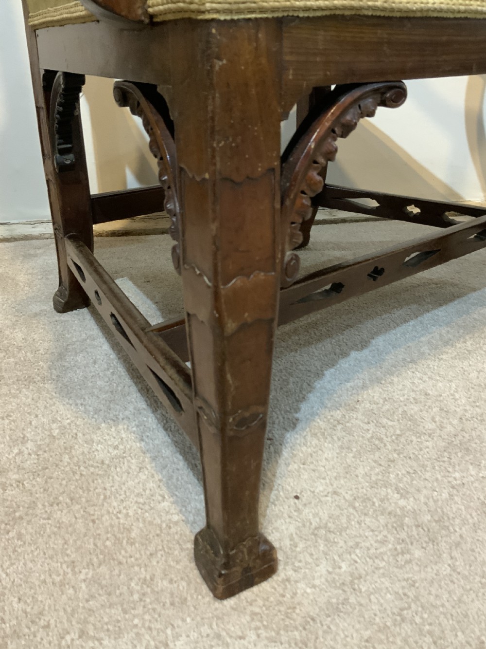 A Georgian dark mahogany armchair featuring an intricately carved pierced back splat, open curved arms, and a green velvet seat with an embroidered tapestry panel. View III