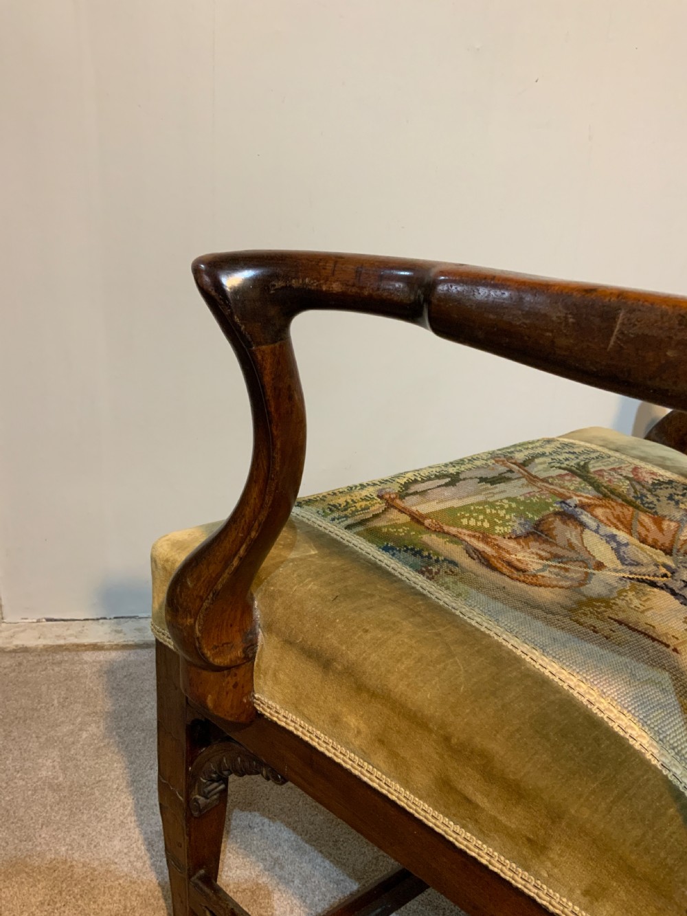 A Georgian dark mahogany armchair featuring an intricately carved pierced back splat, open curved arms, and a green velvet seat with an embroidered tapestry panel. View VII