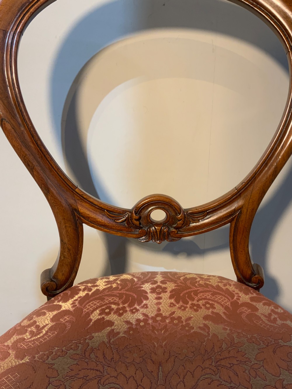 A set of six early Victorian rosewood balloon-back dining chairs with red damask upholstery and cabriole legs. View II