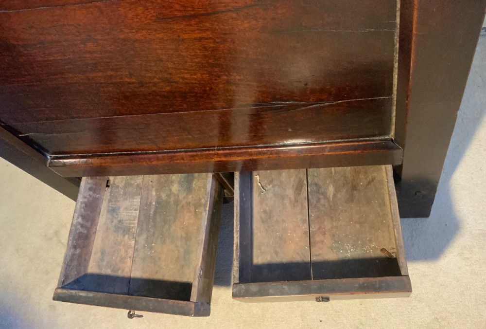 A dark brown 18th-century Chinese wooden chest featuring a top-opening lid, two lower drawers with metal ring handles, and iron latch hardware. View VII