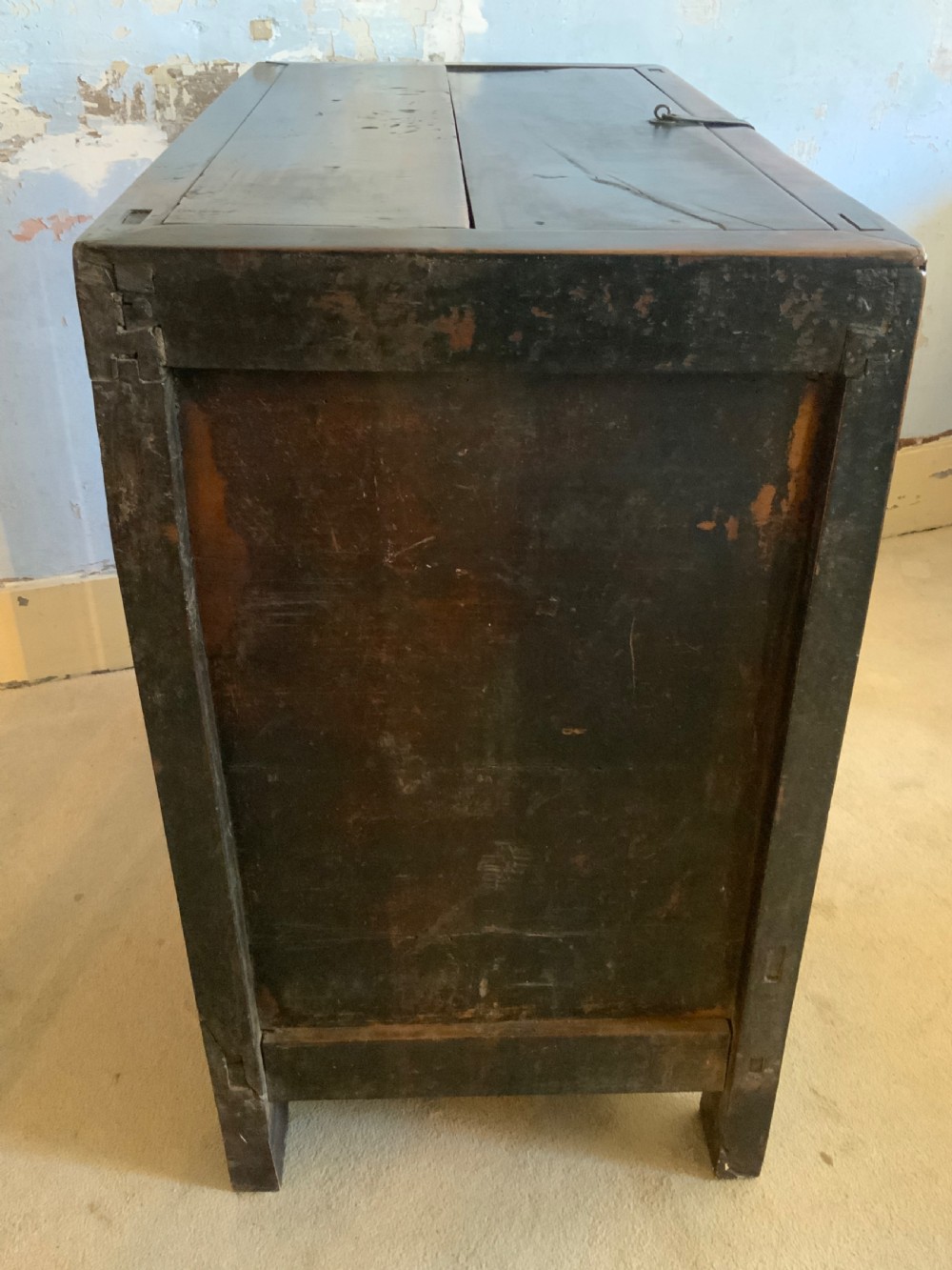 A dark brown 18th-century Chinese wooden chest featuring a top-opening lid, two lower drawers with metal ring handles, and iron latch hardware. View XI