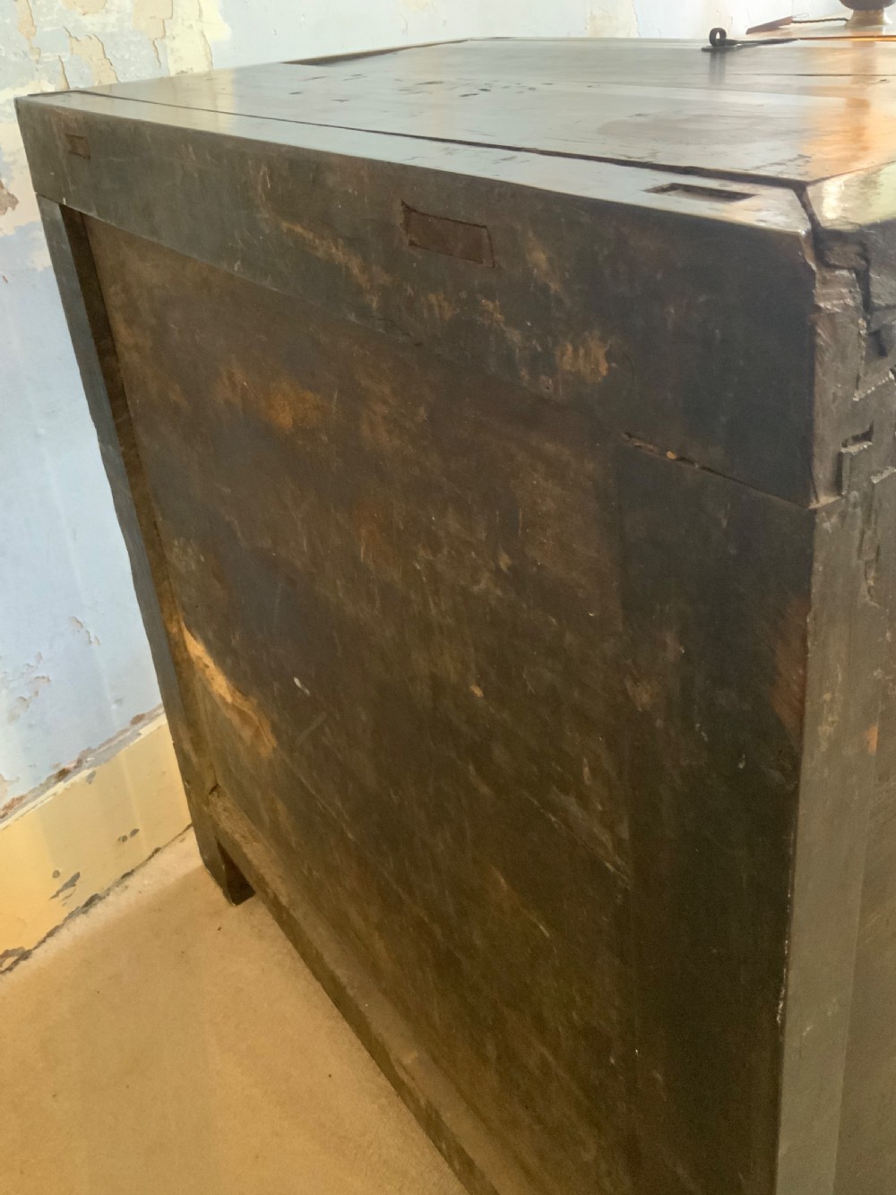 A dark brown 18th-century Chinese wooden chest featuring a top-opening lid, two lower drawers with metal ring handles, and iron latch hardware. View XII