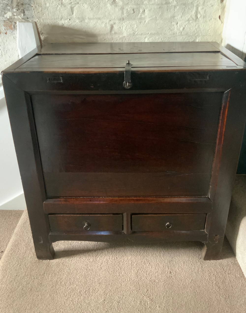 A dark brown 18th-century Chinese wooden chest featuring a top-opening lid, two lower drawers with metal ring handles, and iron latch hardware. View XIII